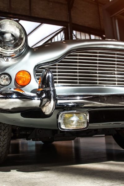 closeup of the headlights and front bumper on a vintage automobile.
